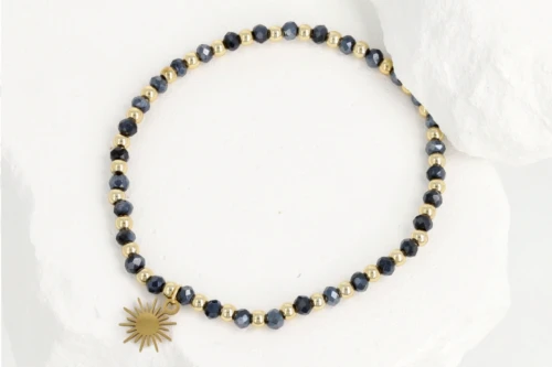 Granatowo-złota bransoletka damska z koralików i zawieszką słońce